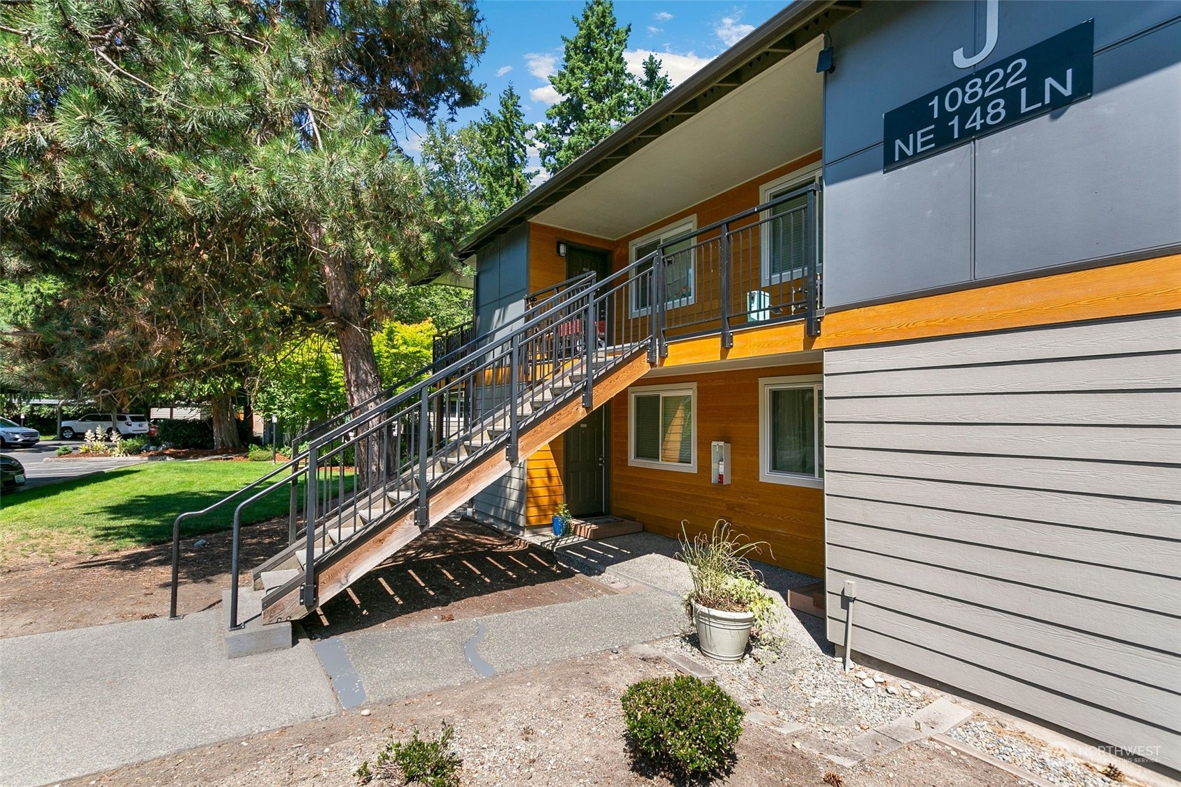 10822 Northeast 148th Lane, Unit J101 Bothell, WA 98011 - Photo 16 of 22 a yellow house with trees in front of it