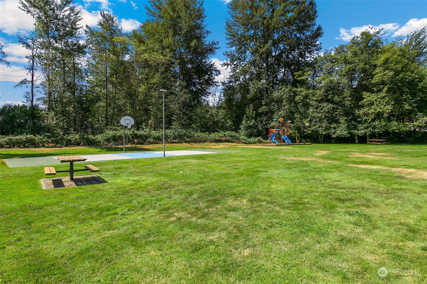 10822 Northeast 148th Lane, Unit J101 Bothell, WA 98011 - Photo 21 of 22 a view of a park with large trees
