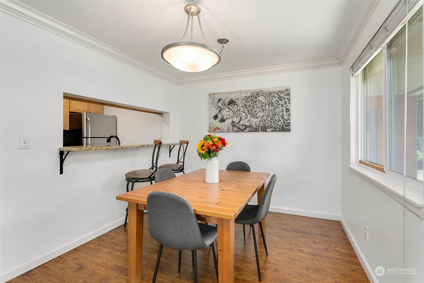 10822 Northeast 148th Lane, Unit J101 Bothell, WA 98011 - Photo 7 of 22 a dining room with furniture and wooden floor