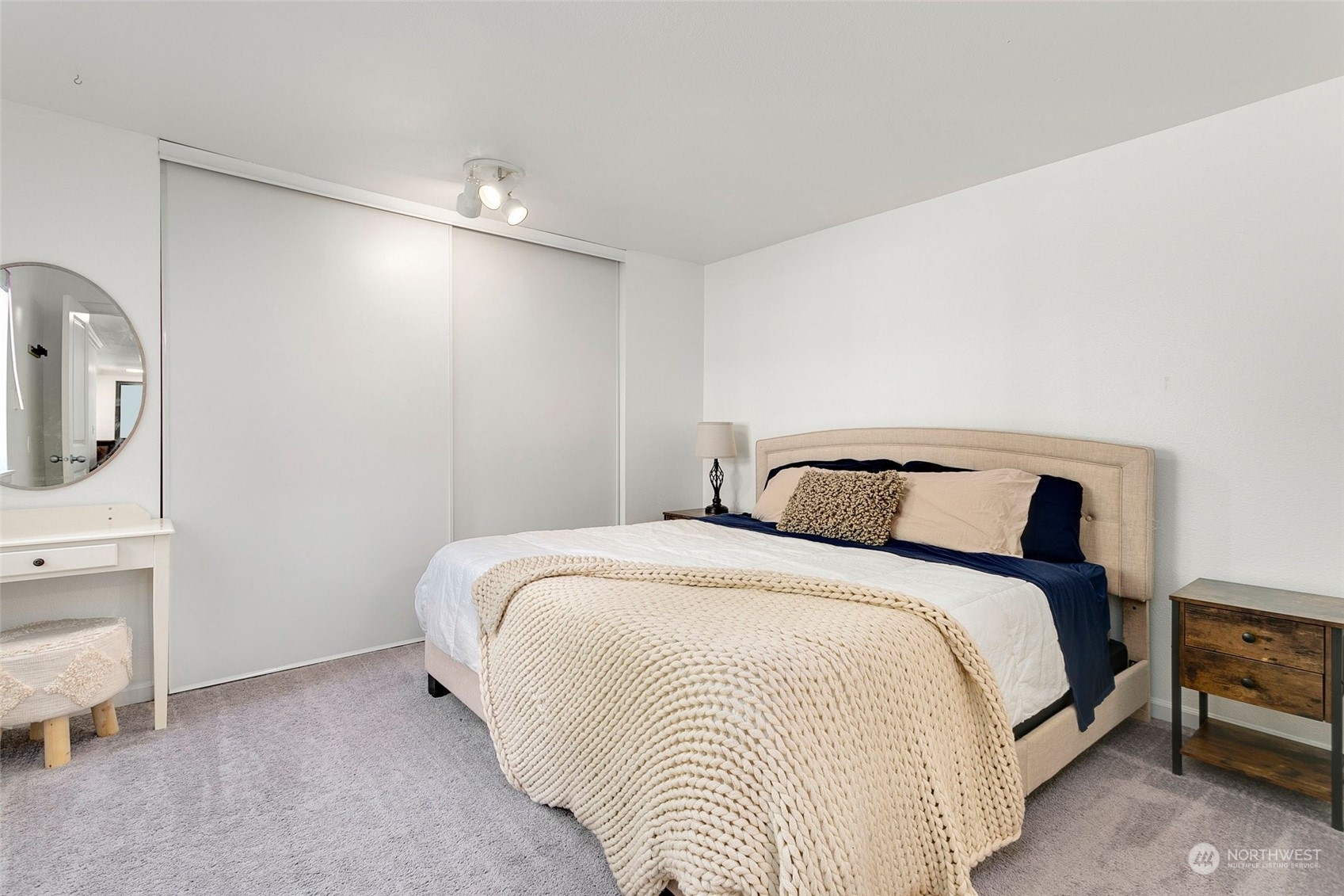 10822 Northeast 148th Lane, Unit J101 Bothell, WA 98011 - Photo 10 of 22 a bedroom with bed and a night stand