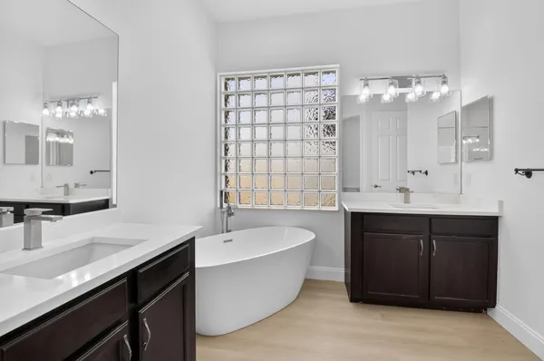 a front view of a house with a garden and plants