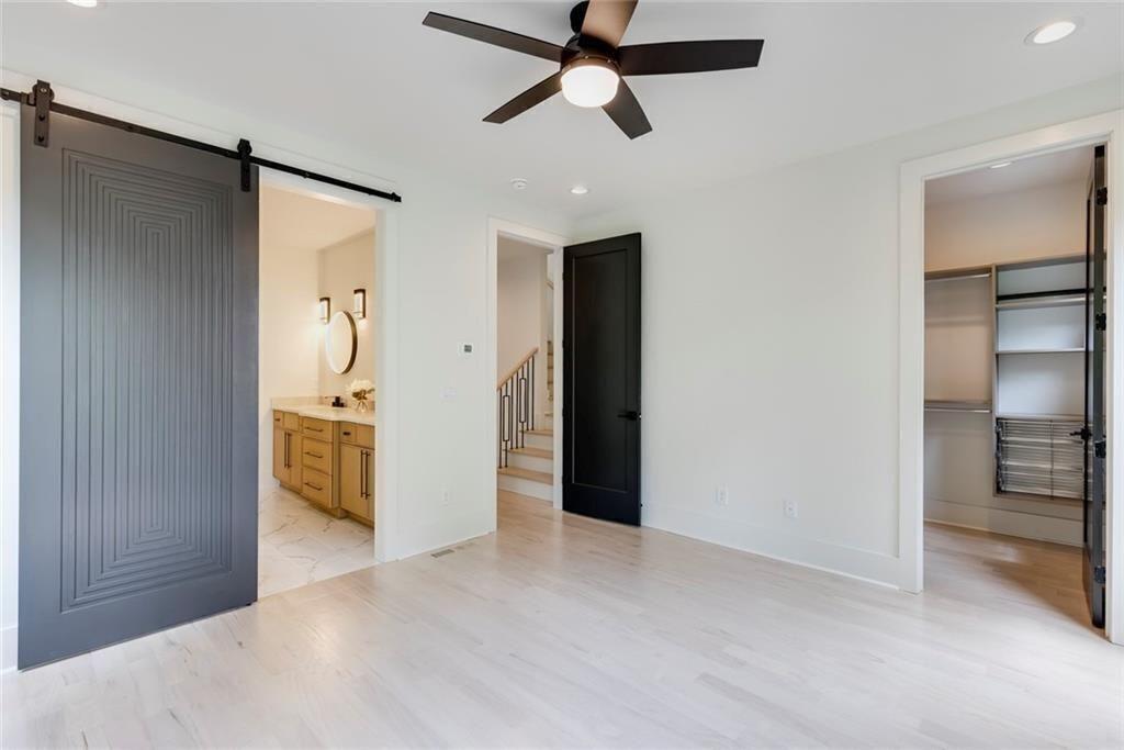 3960 Clairmont Road Chamblee, GA 30341 - Photo 14 of 63 a view of a big room with closet and wooden floor