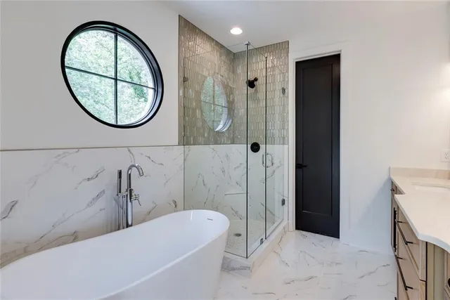 a bathroom with a bathtub and shower