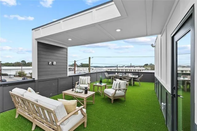 a bathroom with a granite countertop toilet sink and mirror