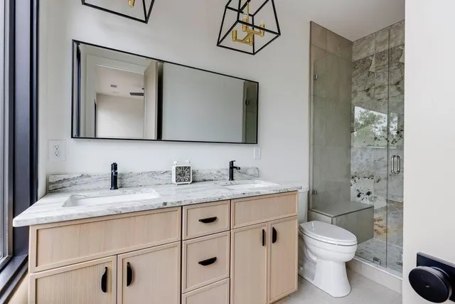 a bathroom with a glass shower door