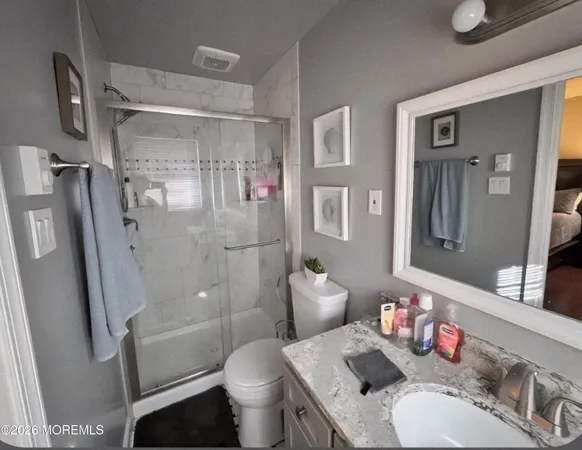 a bathroom with a sink toilet and shower