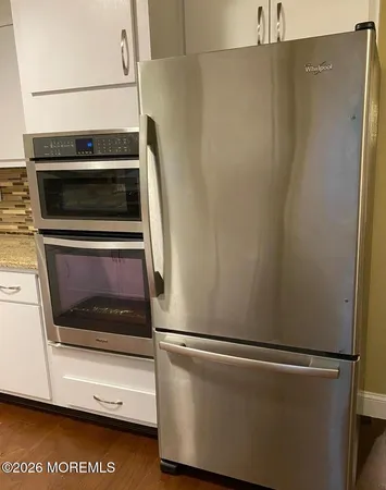 a close view of a stove top oven and refrigerator