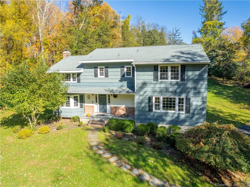 90 Beaver Brook Road Ridgefield, CT 06877 - Photo 1 of 1 a aerial view of a house next to a yard with plants and large trees