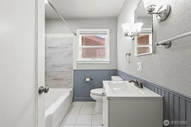 a bathroom with a sink a toilet and bathtub