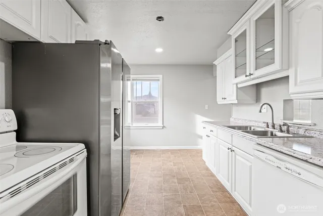 a kitchen with a sink and a refrigerator