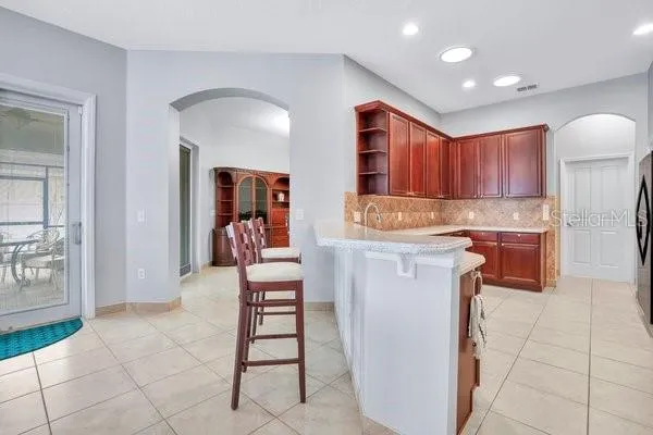 a kitchen with stainless steel appliances granite countertop a refrigerator and a stove top oven