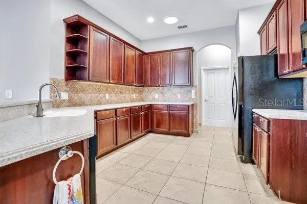 a kitchen with stainless steel appliances granite countertop a sink stove and cabinets