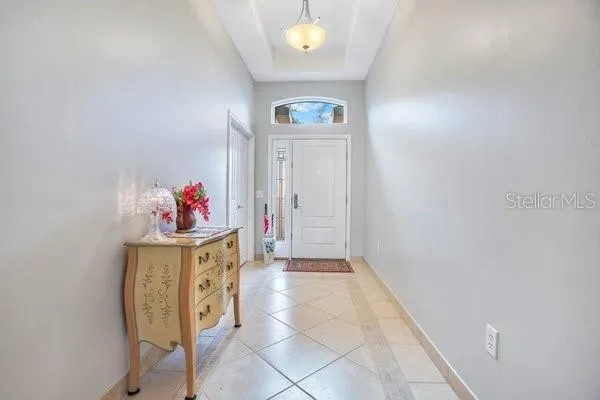 a view of a hallway to room with front door