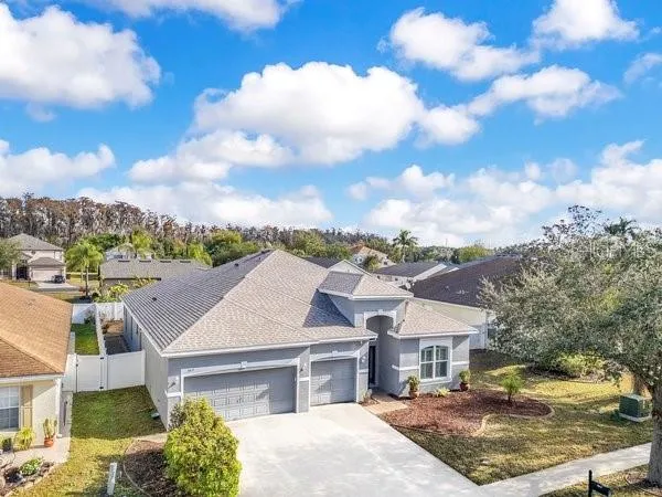 a aerial view of a house with a yard and balcony