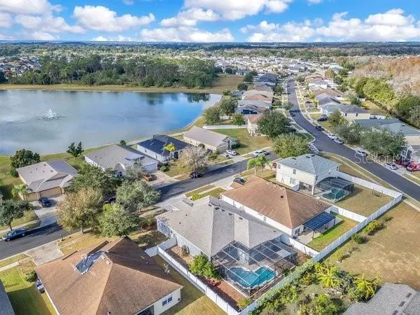 an aerial view of a house with a lake view