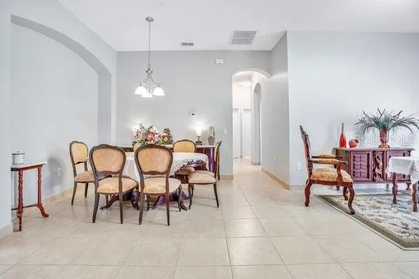 a view of a dining room with furniture and chandelier