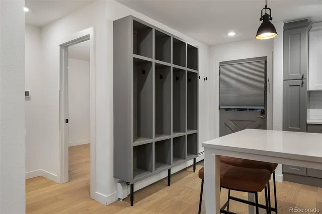 a view of an empty room with a kitchen