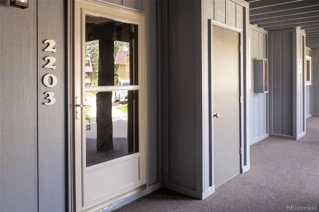 a view of roof deck with couches and wooden fence