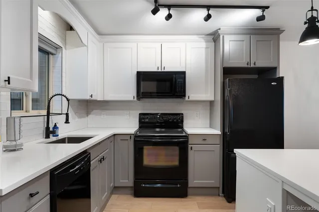 a kitchen with a sink and a stove top oven