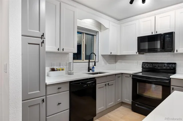 a kitchen with cabinets stainless steel appliances a sink and a microwave