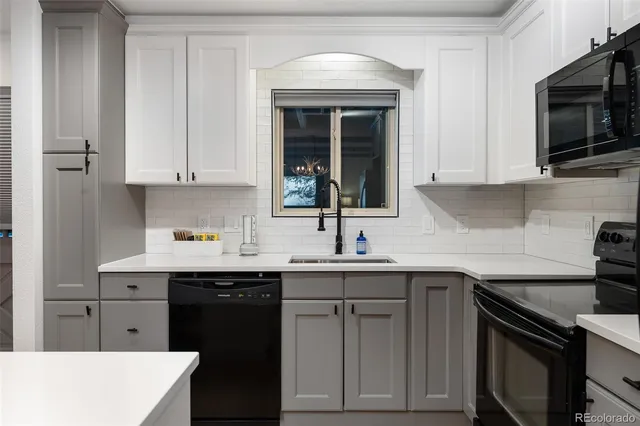 a kitchen with a sink stove and cabinets