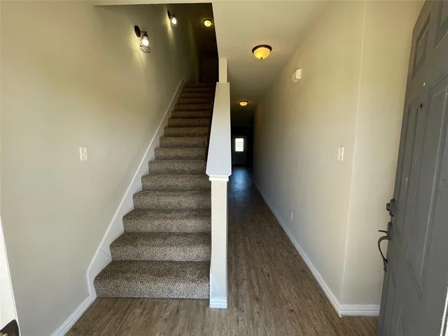 a view of entryway and hall with wooden floor