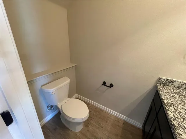 a white toilet sitting next to a sink