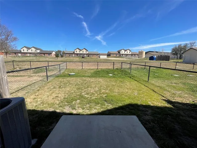a view of a swimming pool with a chair under an umbrella