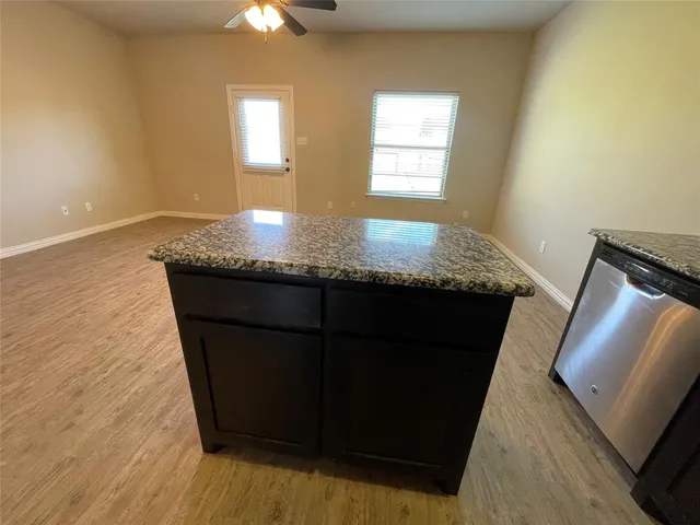 a kitchen with granite countertop white cabinets and a granite counter top