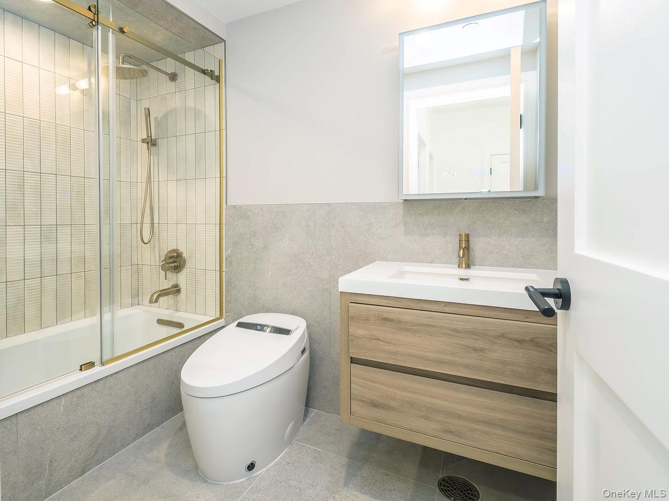 24 Lumber Road, Unit 1 Roslyn, NY 11576 - Photo 10 of 18 a bathroom with a sink a toilet and shower