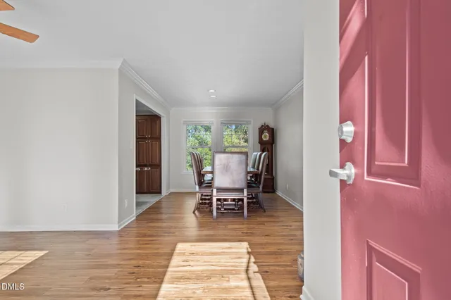 a view of a bedroom with wooden floor and furniture