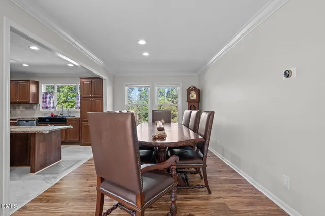 a kitchen with stainless steel appliances granite countertop a refrigerator a sink a stove a oven and a center island