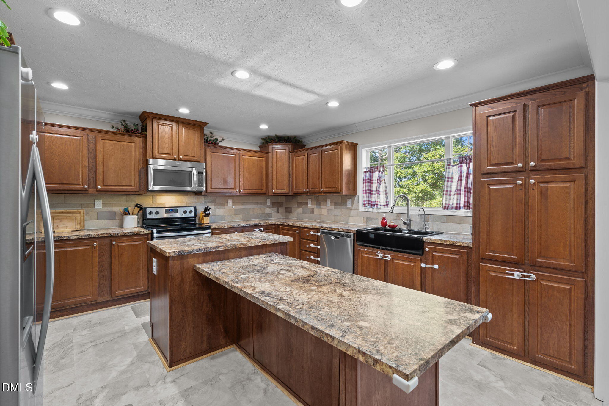 1940 Wadsworth Road Carthage, NC 28327 - Photo 18 of 57 a kitchen with granite countertop stainless steel appliances and wooden cabinets