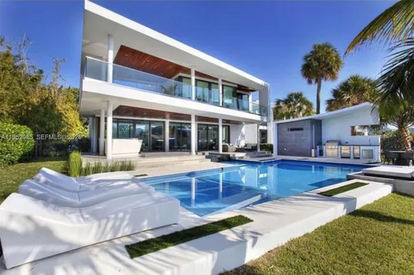 a view of house with swimming pool outdoor seating area