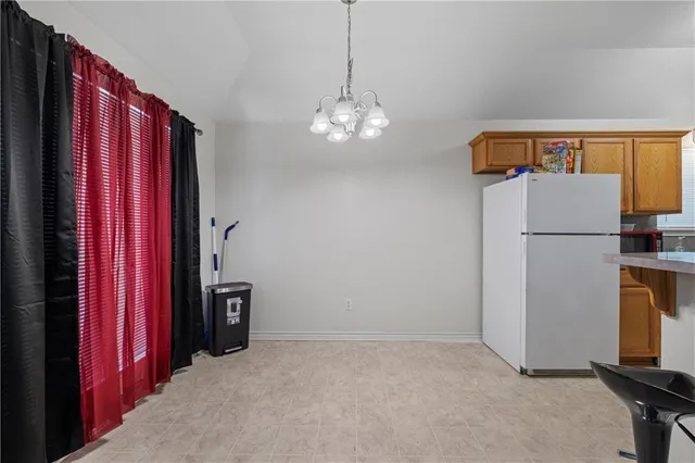 a view of a kitchen with refrigerator and cabinet