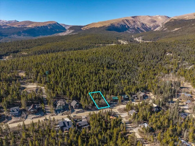 a view of a town with mountains in the background