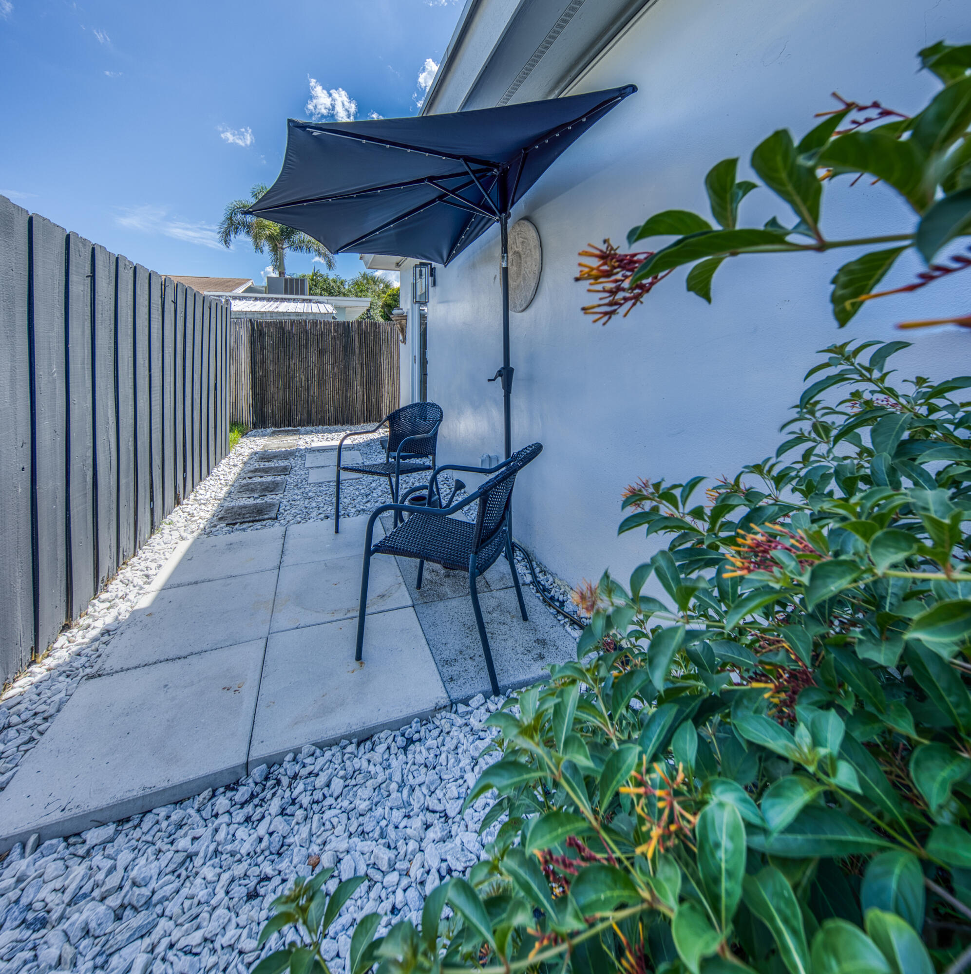 1331 North N Street, Unit GUEST HOUSE Lake Worth Beach, FL 33460 - Photo 12 of 23 a view of a patio with table and chairs and potted plants