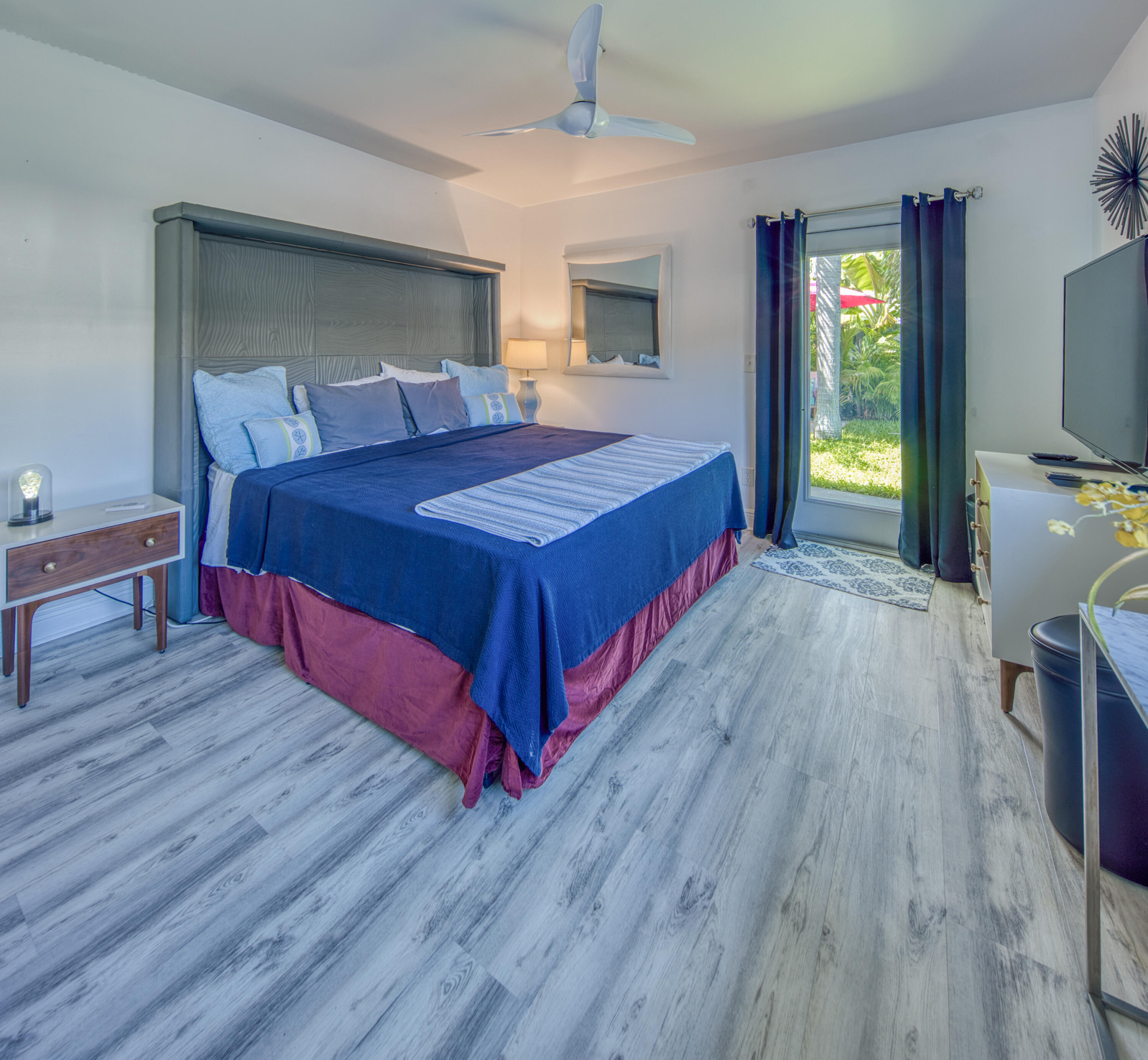 1331 North N Street, Unit GUEST HOUSE Lake Worth Beach, FL 33460 - Photo 5 of 23 a bedroom with a bed and a flat tv screen on dresser