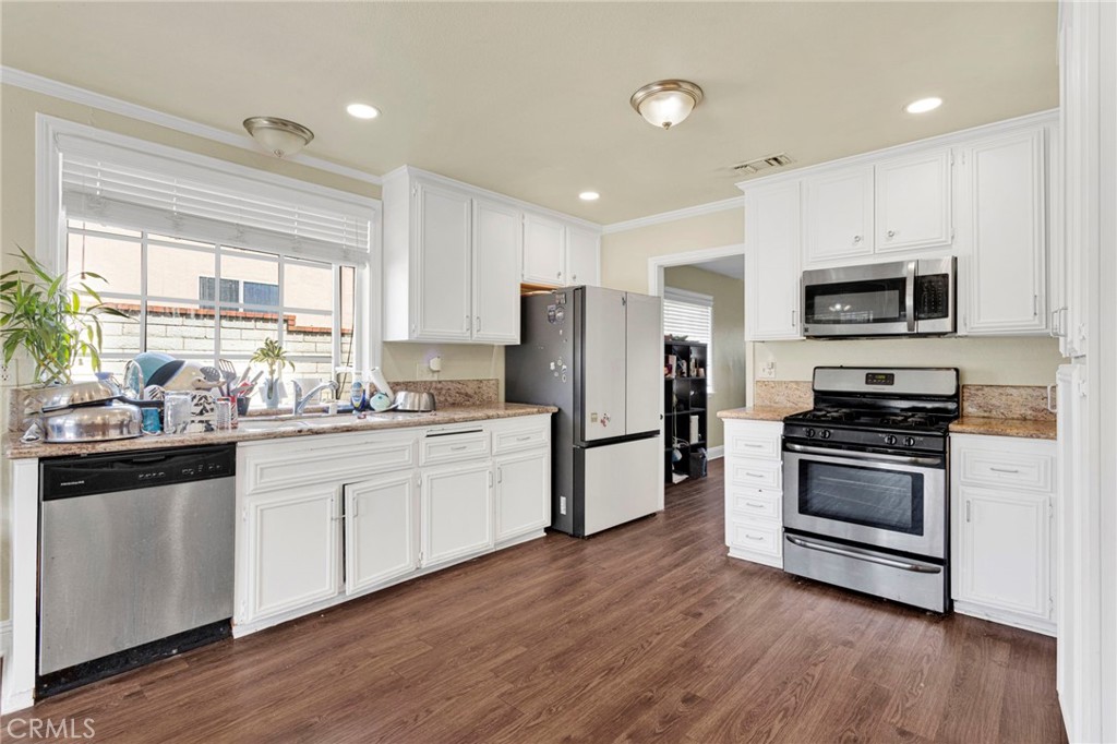 1087 Baseline Road La Verne, CA 91750 - Photo 15 of 39 a kitchen with refrigerator a stove a sink and a microwave