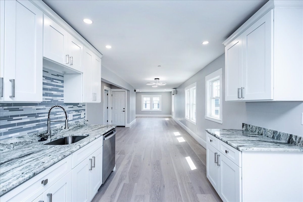 22 Berkley Road, Unit 2 Hull, MA 02045 - Photo 11 of 39 a kitchen with stainless steel appliances granite countertop a sink stove and cabinets