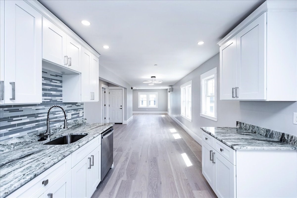 22 Berkley Road, Unit 2 Hull, MA 02045 - Photo 12 of 39 a kitchen with stainless steel appliances granite countertop a sink stove and cabinets