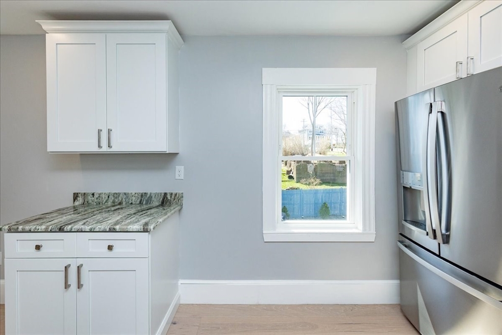 22 Berkley Road, Unit 2 Hull, MA 02045 - Photo 13 of 39 a kitchen with appliances cabinets and a window