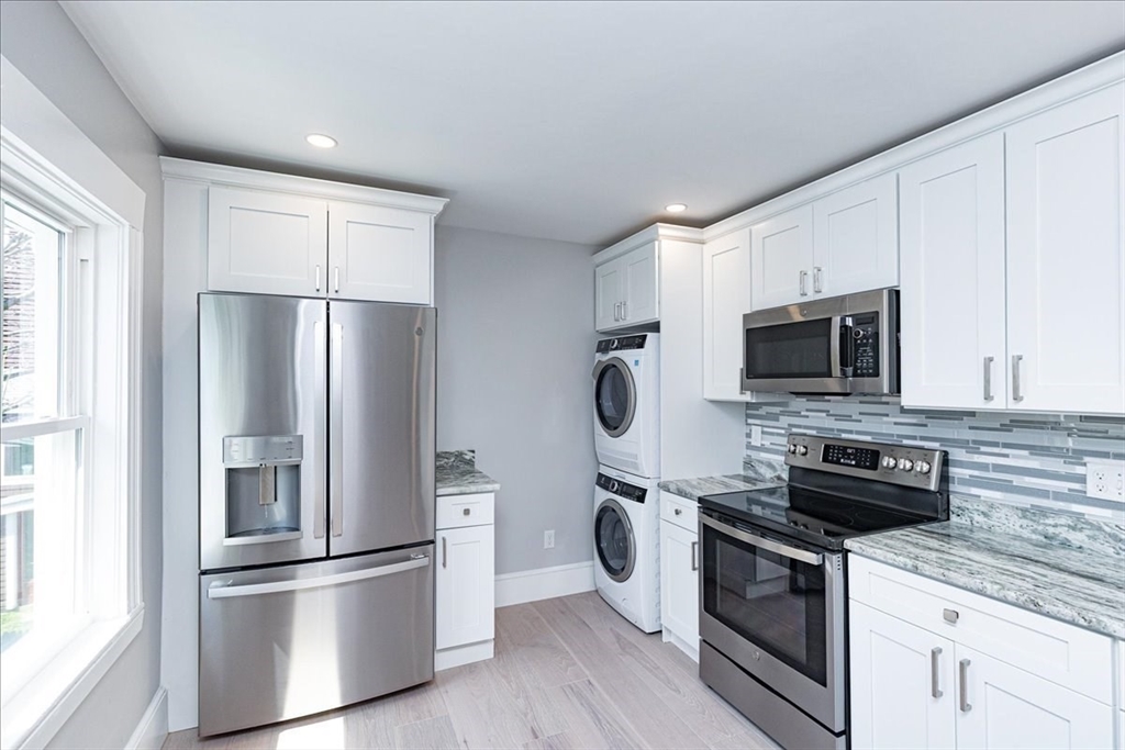 22 Berkley Road, Unit 2 Hull, MA 02045 - Photo 17 of 39 a kitchen with stainless steel appliances a refrigerator stove and microwave