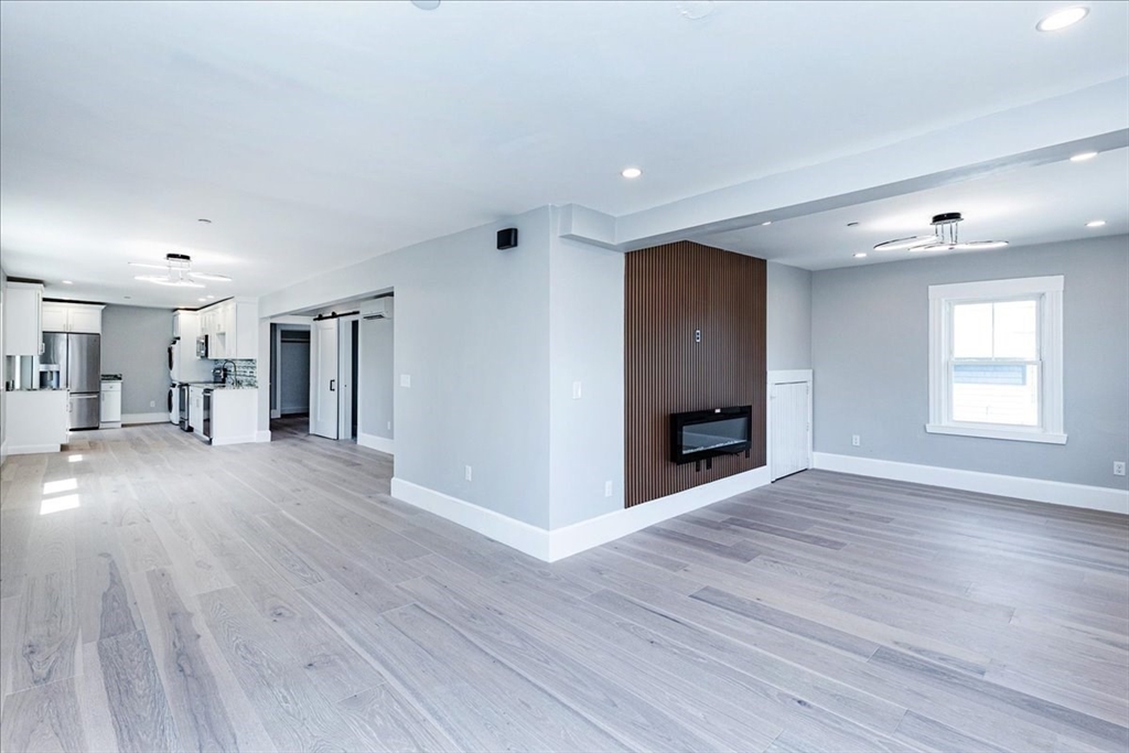 22 Berkley Road, Unit 2 Hull, MA 02045 - Photo 20 of 39 a view of a livingroom with wooden floor and a kitchen