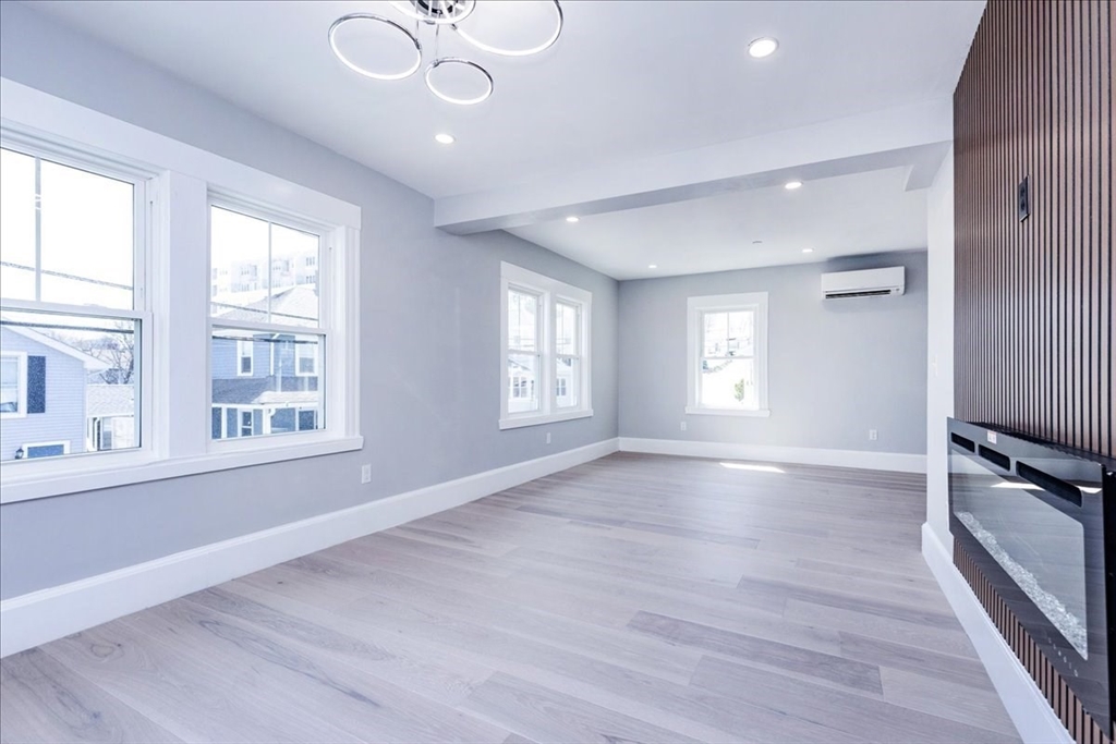 22 Berkley Road, Unit 2 Hull, MA 02045 - Photo 22 of 39 a view of an empty room with wooden floor and a window