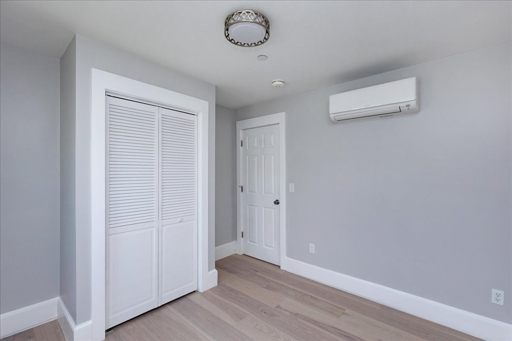 22 Berkley Road, Unit 2 Hull, MA 02045 - Photo 30 of 39 a view of a hallway with wooden floor