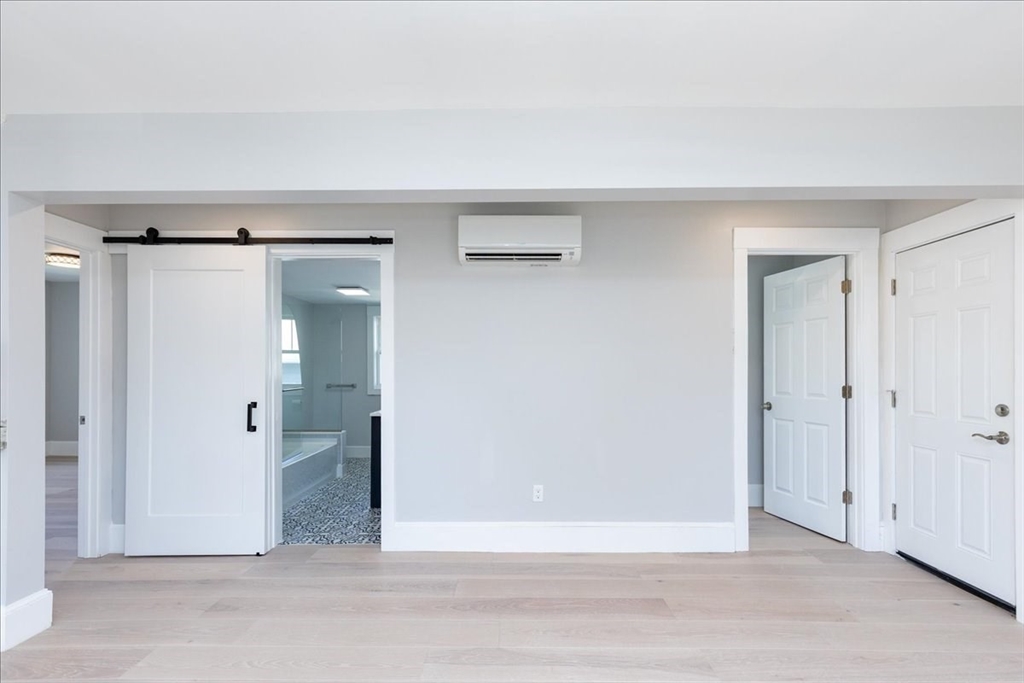 22 Berkley Road, Unit 2 Hull, MA 02045 - Photo 9 of 39 a view of a livingroom with wooden floor and a bathroom