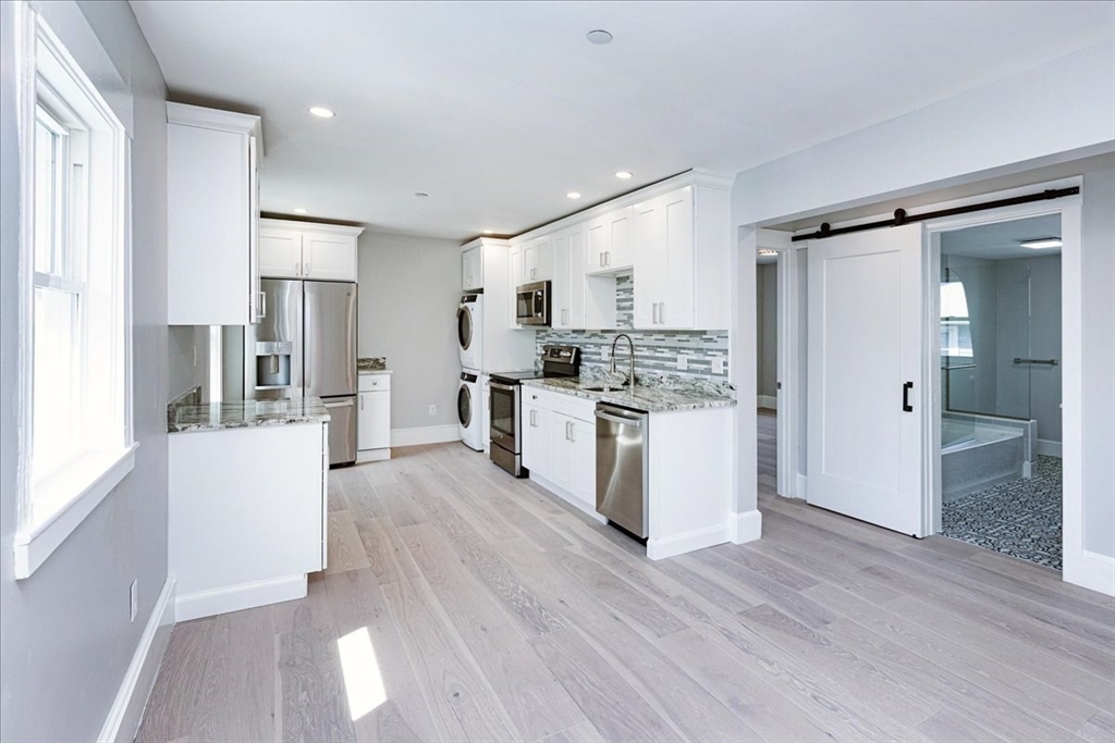 22 Berkley Road, Unit 2 Hull, MA 02045 - Photo 10 of 39 a kitchen with stainless steel appliances a refrigerator and a stove top oven