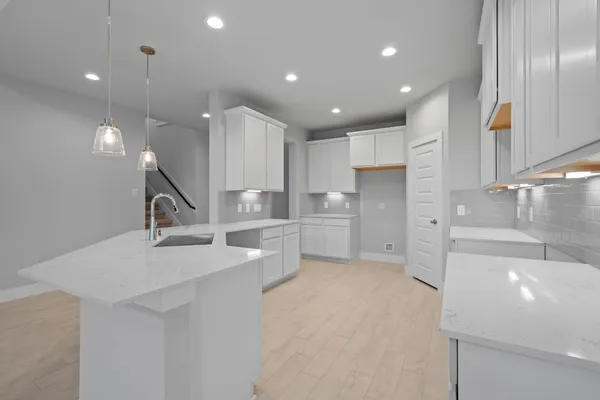 a open kitchen with kitchen island a sink stainless steel appliances and cabinets