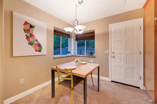 a dining room with furniture and window